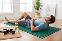 Athletic man using acupressure mat after workout