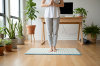Person standing on acupressure mat for foot therapy